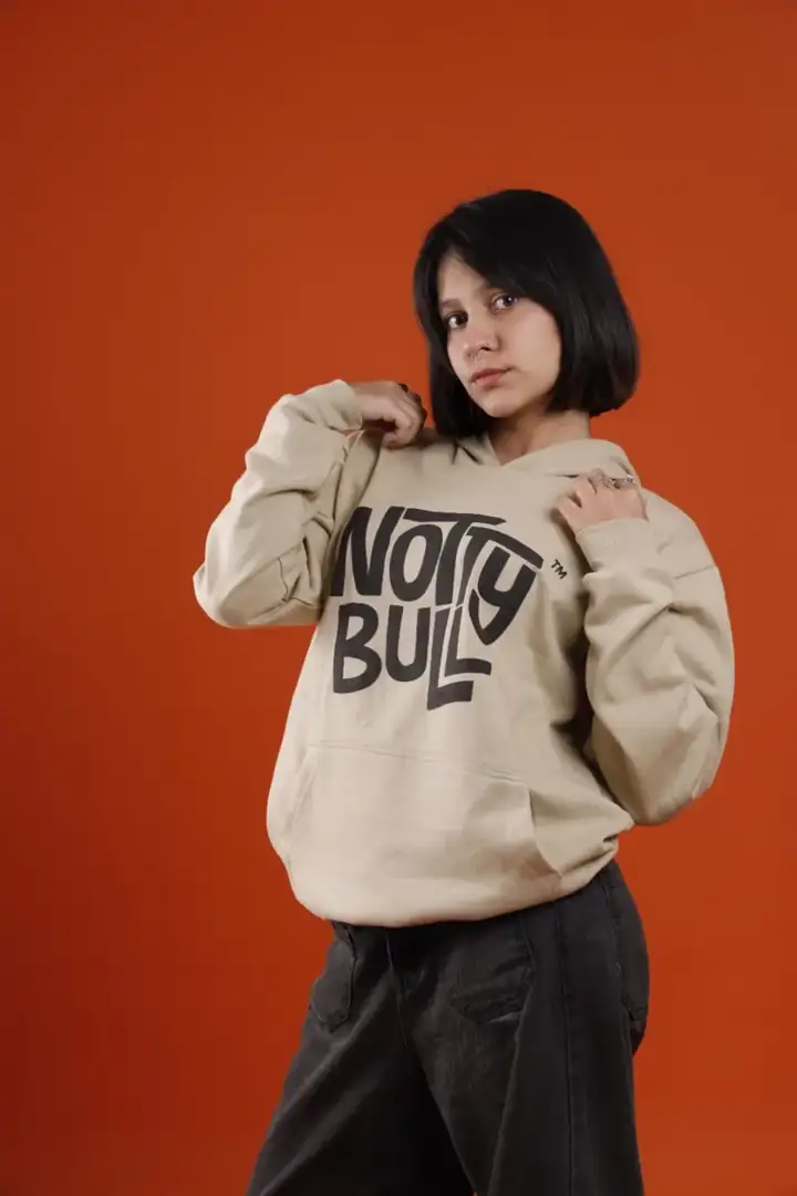 Model in the sand puff-print NottyBull hoodie