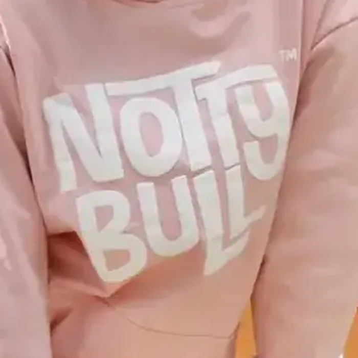Close-up of the raised puff print on the pink hoodie